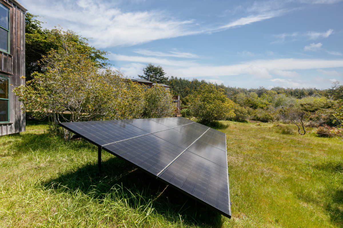 Solar panel in a grassy outdoor setting.
