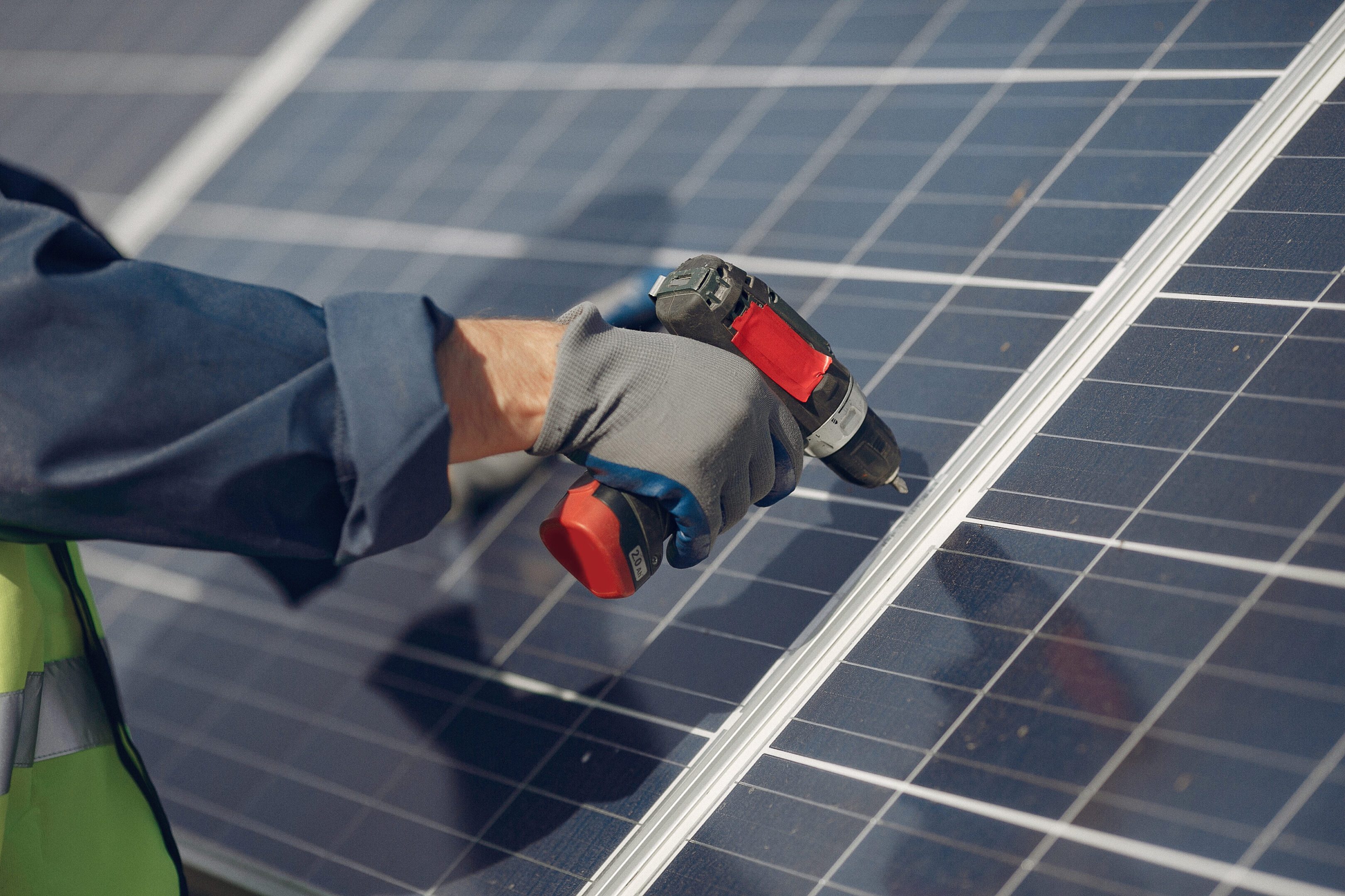 Man in a white helmet near a solar panel Engineer in a white helmet. Man near solar panel.